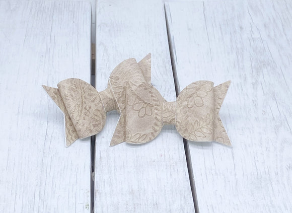 Tan embossed leather bitty bow
