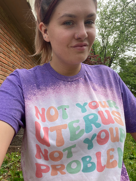 Not your uterus not your problem tee shirt shown on bleached heather purple
