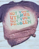 Not your uterus not your problem tee shirt shown on bleached heather purple