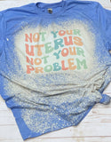 Not your uterus not your problem tee shirt shown on bleached heather purple