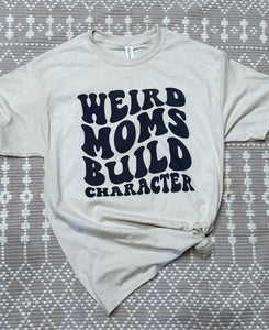 Weird moms build character tee shirt shown on sand