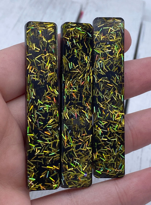 Black and gold resin clip